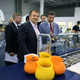 Mikhail Kokorich visits SpaceX headquarters in 2012 alongside then-Roscosmos director Vladimir Popovkin, with Elon Musk in the background.